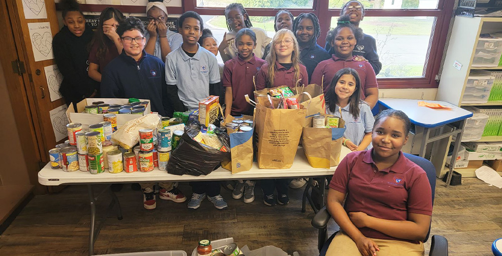 Random Acts of Kindness Club Donates Over 500 Cans to Food Bank of CNY
